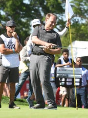 Michigan State basketball coach Tom Izzo tries a little body English on his putt on the 15th green during Tuesday's Area 313 Celebrity Challenge at the Detroit Golf Club in Detroit.