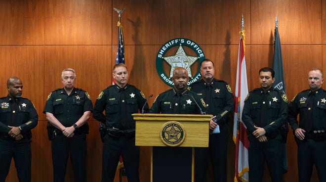 Broward Sheriff Gregory Tony, center, announces that two additional deputies have been fired as a result of the agency's internal affairs investigation into the mass shooting at Marjory Stoneman Douglas High School in Parkland, at the Broward Sheriff's Office headquarters in Fort Lauderdale, Fla., Wednesday, June 26.