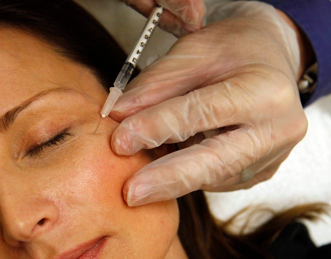 In this June 5, 2009, photo a woman has Botox injected at Reveal in Arlington, Va.