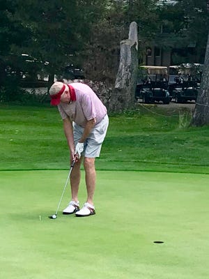 Former Ohio State men's basketball All-American Bill Hoskett putts the ball during this year's Charity-Celebrity Golf Outing at the Marion Country Club.