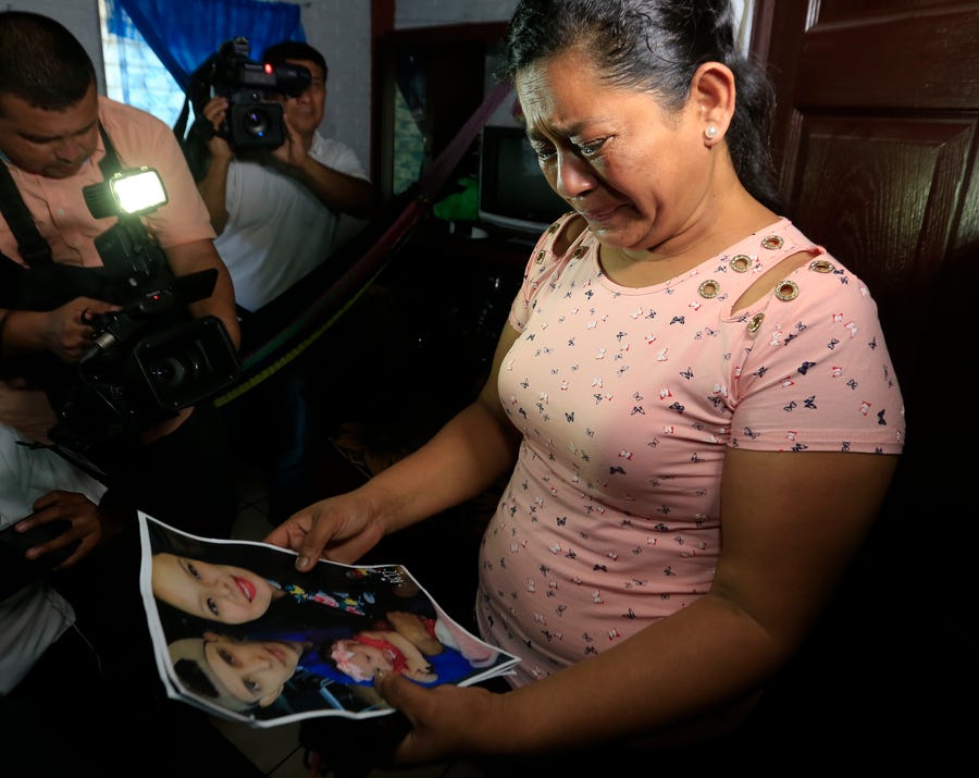 Rosa Ramirez cries when shown a photograph printed from social media of her son Oscar Alberto Martinez Ramírez, 25, granddaughter Valeria, nearly 2, and her daughter-in-law Tania Vanessa Avalos, 21, while speaking to journalists at her home in San Martin, El Salvador, Tuesday, June 25, 2019. The drowned bodies of her son and granddaughter were located Monday morning on the banks of the Rio Grande, a day after the pair were swept away by the   current when the young family tried to cross the river to Brownsville, Texas. Her daughter-in-law survived. (AP Photo/Antonio Valladares) ORG XMIT: SLV101
