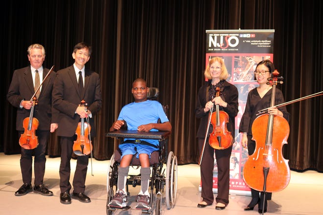 Matheny School student Jameir Warren Treadwell joins NJ Symphony Orchestra members John Connelly, James Tsao, Lucille Corwin and Hyewon Kim on the stage of the Robert Schonhorn Arts Center.