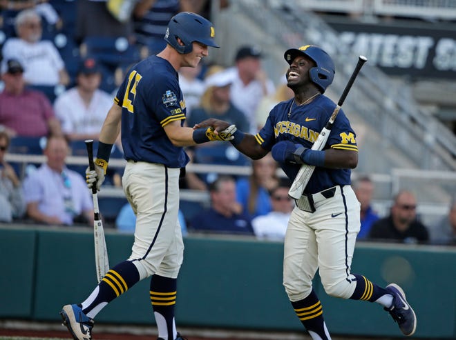 Michigan's Ako Thomas, right, and Jimmy Kerr (15) were both named to the College World Series All-Tournament team.
