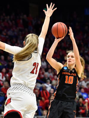 Oregon State guard Katie McWilliams (10) shoots against Louisville forward Kylee Shook (21) during the Lexington regional on Mar 25, 2018.