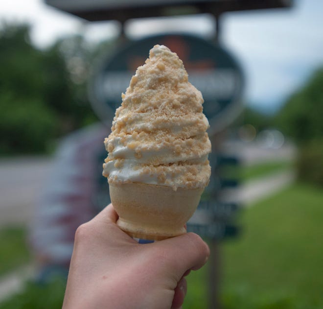 Reporter Sawyer Loftus holds his maple creemee with maple sprinkles outside Palmer Lane Maple in Jericho, VT, June 26, 2019. 