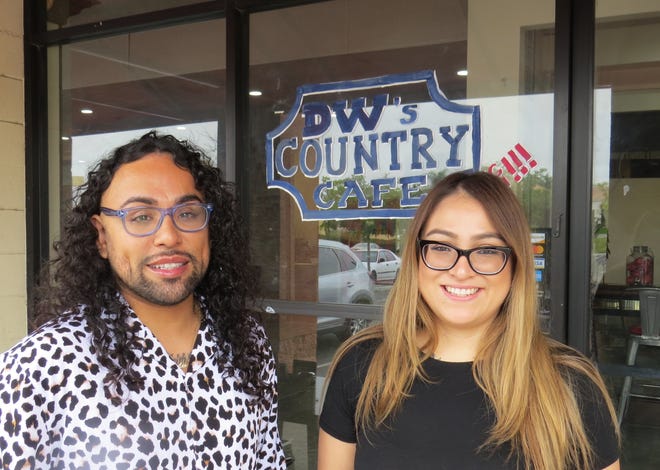 Cousins Joseph "Jo Jo" Morales Ramirez, left, and Alexia Garcia pose outside the new Ventura location of their family-owned restaurant, DW's Country Cafe.