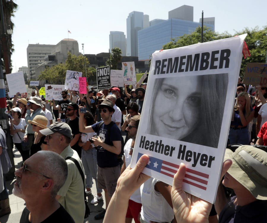 A demonstrator in Los Angeles holds up a picture of Heather Heyer during a  demonstration in front of City Hall for victims of Charlottesville, Virginia tragedy and against racism on August 13, 2017.