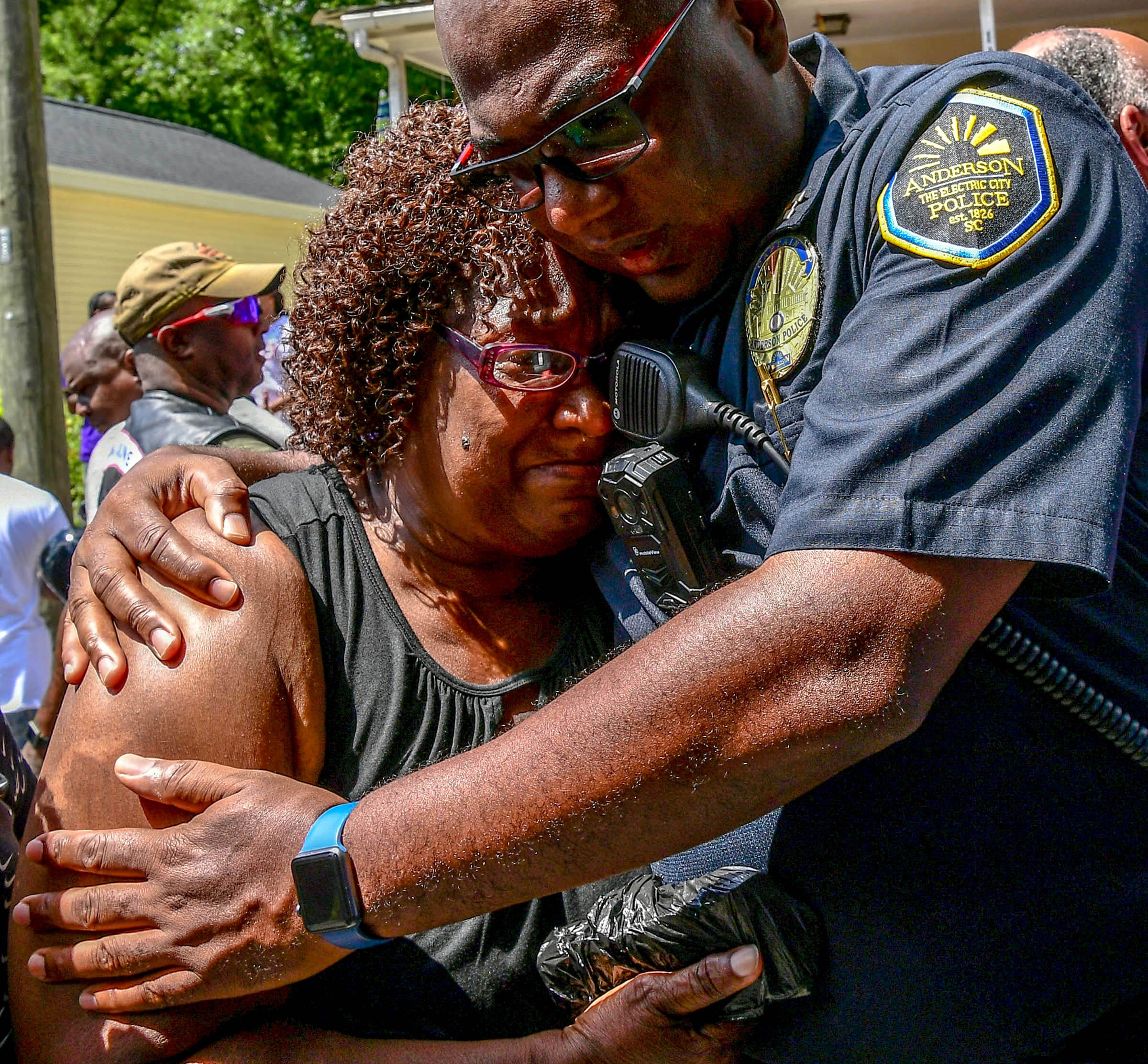 Nora Rice, left, grandmother of Ja'Naiya Scott, gets a hug from Captain Mike Aikens, right, after Upstate Bikers group organizer Tim Irvin presented her with money at the Biker Unity Ride Against Violence for Ja'Naiya Scott, from Greenville to her home in Anderson Saturday. The biker group offered Rice and family of Ja'Naiya Scott their support and the gift. Ja'Naiya Scott, 11, died after 35 gun shots were fired at the house on West End Avenue early Sunday, June 23. Police are looking for more tips in finding the shooter.