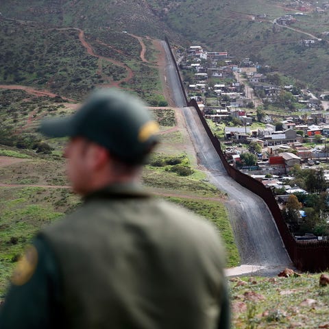Border Patrol agent Vincent Pirro looks on near a...