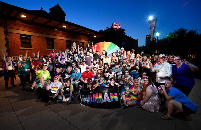 Near the end of the evening Saturday, attendees of Pride in the Park gather for a group photo in Everman Park. Organizers called the evening a celebration of the Abilene area LGTBQ community