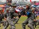 Soldiers of the Chinese People's Liberation Army (PLA) demonstrate their skills during an open day at Stonecutter Island naval base, in Hong Kong to mark the 22nd anniversary of Hong Kong's handover to China. 
