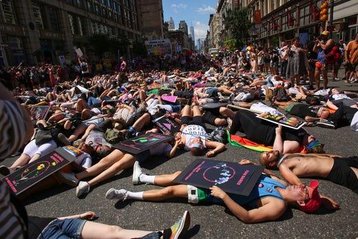 Activists lie on Sixth Avenue during the Queer Liberation March in New York City. The march marks the 50th anniversary of the Stonewall riots in the Greenwich Village neighborhood of Manhattan on June 28, 1969, widely considered a watershed moment in the modern gay-rights movement. The Queer Liberation March, organized by the Reclaim Pride Coalition, began as a protest of the much larger NYC Pride March, which some have accused of being too corporate-sponsored and too strict on participation requirements. 