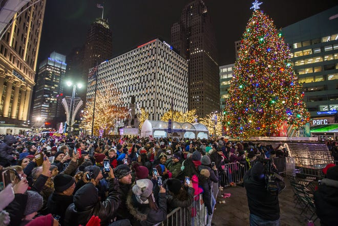 People take photos as the tree is lit during the annual tree lighting event at Campus Martius Park in downtown Detroit on Friday, November 16, 2018.