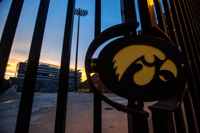 A Tigerhawk logo on an entrance gate is pictured as the sun sets, Sunday, June 30, 2019, at Kinnick Stadium in Iowa City, Iowa.