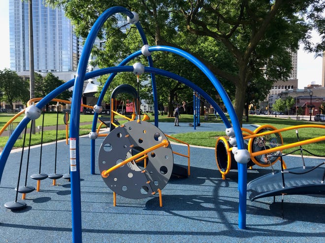There are climbing structures, stepping stones, a bridge, tunnel and a small slide on this playground equipment at Cathedral Square Park.
