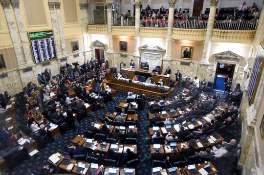 State delegates work in the Maryland House of Delegates chamber in Annapolis on the final day of the state's 2019 legislative session. Laws to protect students from sexual abuse, focus on high prescription drug costs and protect oysters in the Chesapeake Bay are among the new laws taking effect in Maryland this week.