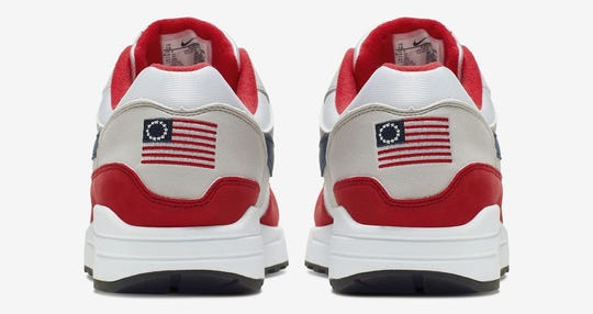 The shoe’s heel has a U.S. flag with 13 white stars in a circle on it, known as the Betsy Ross flag.