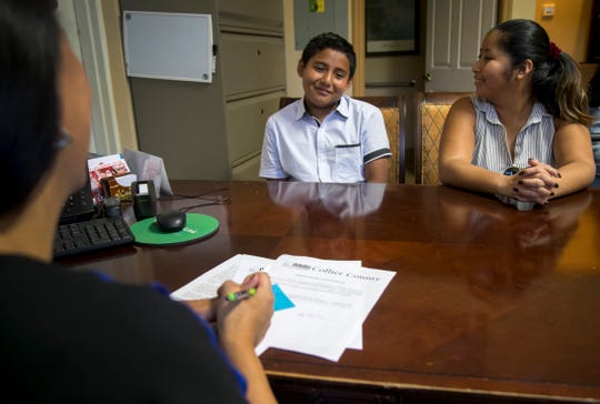 Maria Helena Morales, right, smiles at her son Ronny, 13, as they meet with HUGS system navigator Adriana Gyorkos at an office of NAMI Collier County on June 28, 2019, in Naples. Morales sought help for her son through NAMI's HUGS program, which stands for Health Under Guided Systems, and helps with mental health screenings, system navigation, referrals and support groups. NAMI Collier County benefits from money raised at the Naples Winter Wine Festival.