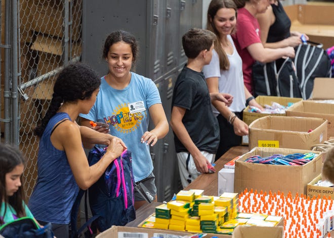 Volunteers work at the Lafayette Parish School System warehouse, stuffing backpacks with school supplies to be donated to thousands of students at eight Lafayette Parish schools as part of the Love Our Schools initiative. Through the program, nearly 5,000 students will receive backpacks filled with school supplies.  Tuesday, July 2, 2019.