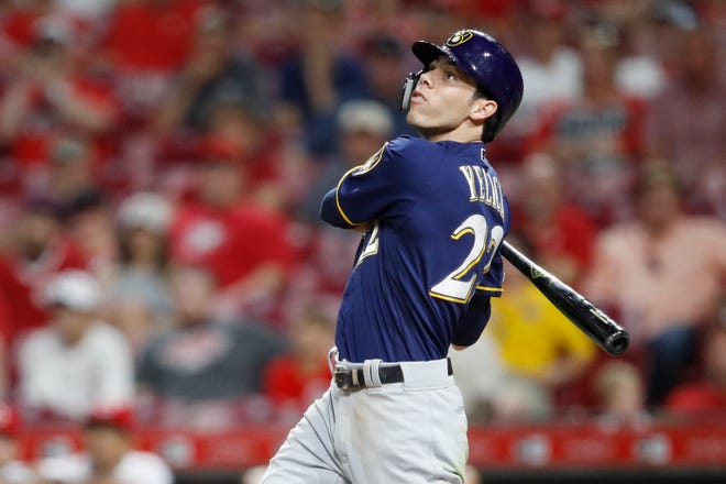 Christian Yelich watches his two-run home run in the ninth inning, his 30th of the season.