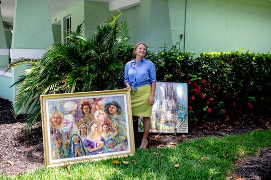Olena Skiba stands with her artwork at the Naples Art Association in Naples on May 30, 2019.  Skiba, from Ukraine, has made a home for herself in Naples and works as an artist.