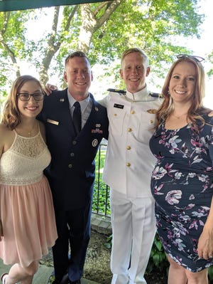 Andrew Lang, center right, celebrating with family after his graduation from the U.S. Merchant Marine Academy.