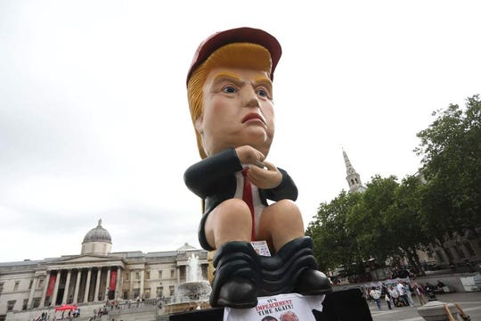 A picture shows a protest sculpture depicting US President Donald Trump on a toilet using a smartphone as protesters against the US president's State Visit gather in Trafalgar Square in central London on June 4, 2019, on the second day of Trump's three-day State Visit to the UK. - US President Donald Trump turns from pomp and ceremony to politics and business on Tuesday as he meets Prime Minister Theresa May on the second day of a state visit expected to be accompanied by mass protests. (Photo by ISABEL INFANTES / AFP)ISABEL INFANTES/AFP/Getty Images ORIG FILE ID: AFP_1H805E