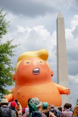 A baby Trump balloon is displayed near the Washington Memorial on July 4, 2019.