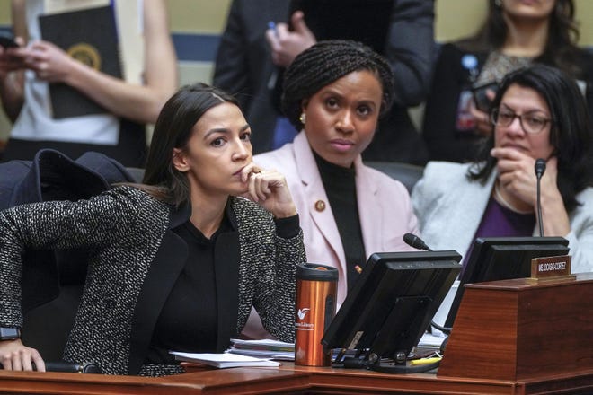 Rep. Alexandria Ocasio-Cortez, D-N.Y., left, joined by Rep. Ayanna Pressley, D-Mass., and Rep. Rashida Tlaib, D-Mich., listens during a House Oversight and Reform Committee meeting, on Capitol Hill in Washington Feb. 26.