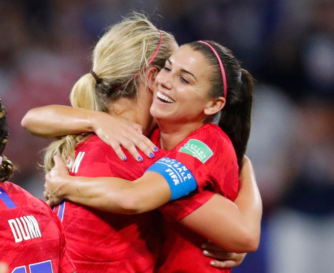 United States forward Alex Morgan (right) hugs midfielder Lindsey Horan (left) after defeating England during semi-final play in the FIFA Women's World Cup France 2019 soccer tournament at Stade de Lyon on Tuesday.