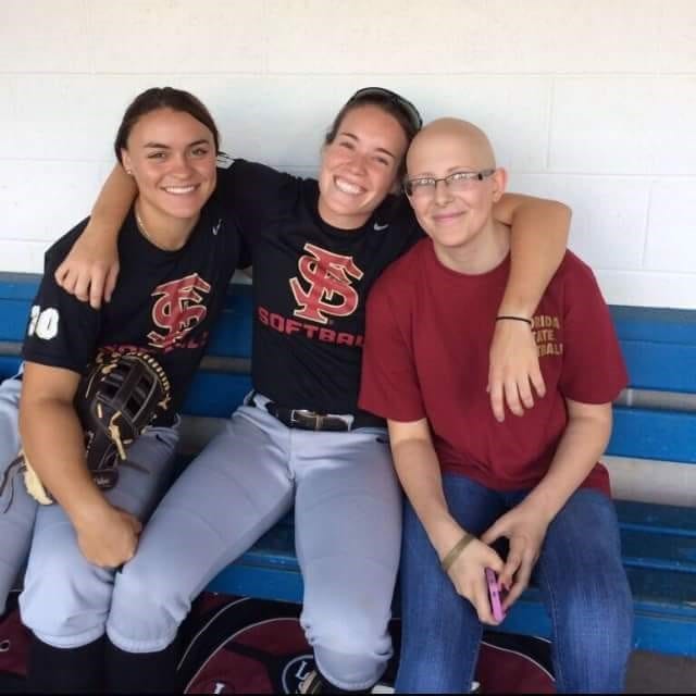 Taylor Foster (right) with Macey Cheatham (center) on one of her many visits with the FSU softball team.