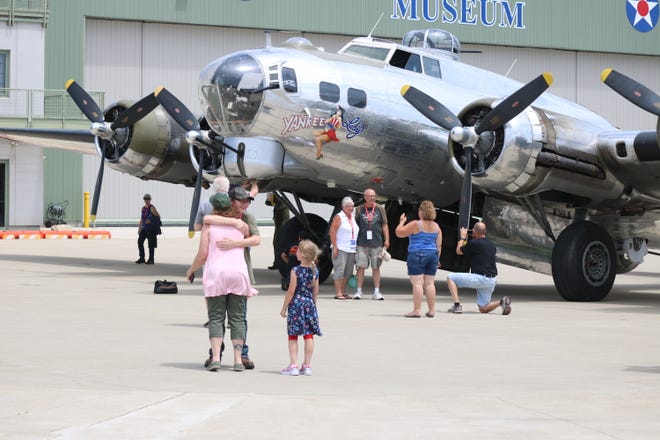 Joshua Pittman, left, gives his mother a hug just after finishing his flight aboard the B-17 Yankee Lady on Saturday.