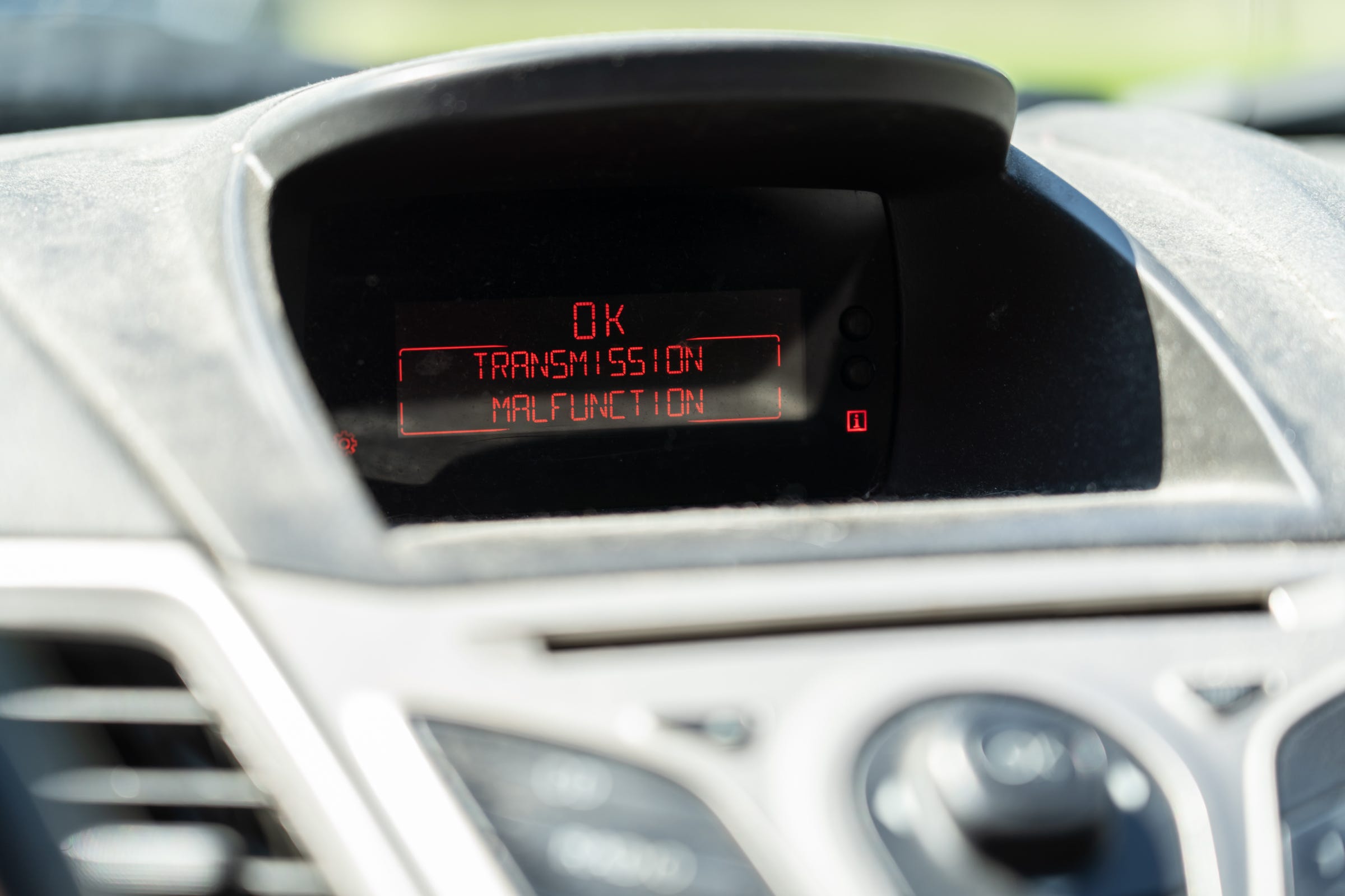 A transmission malfunction message is displayed in Michelle Hughes' 2012 Ford Fiesta parked at her home in Flint on Wednesday, June 26, 2019.