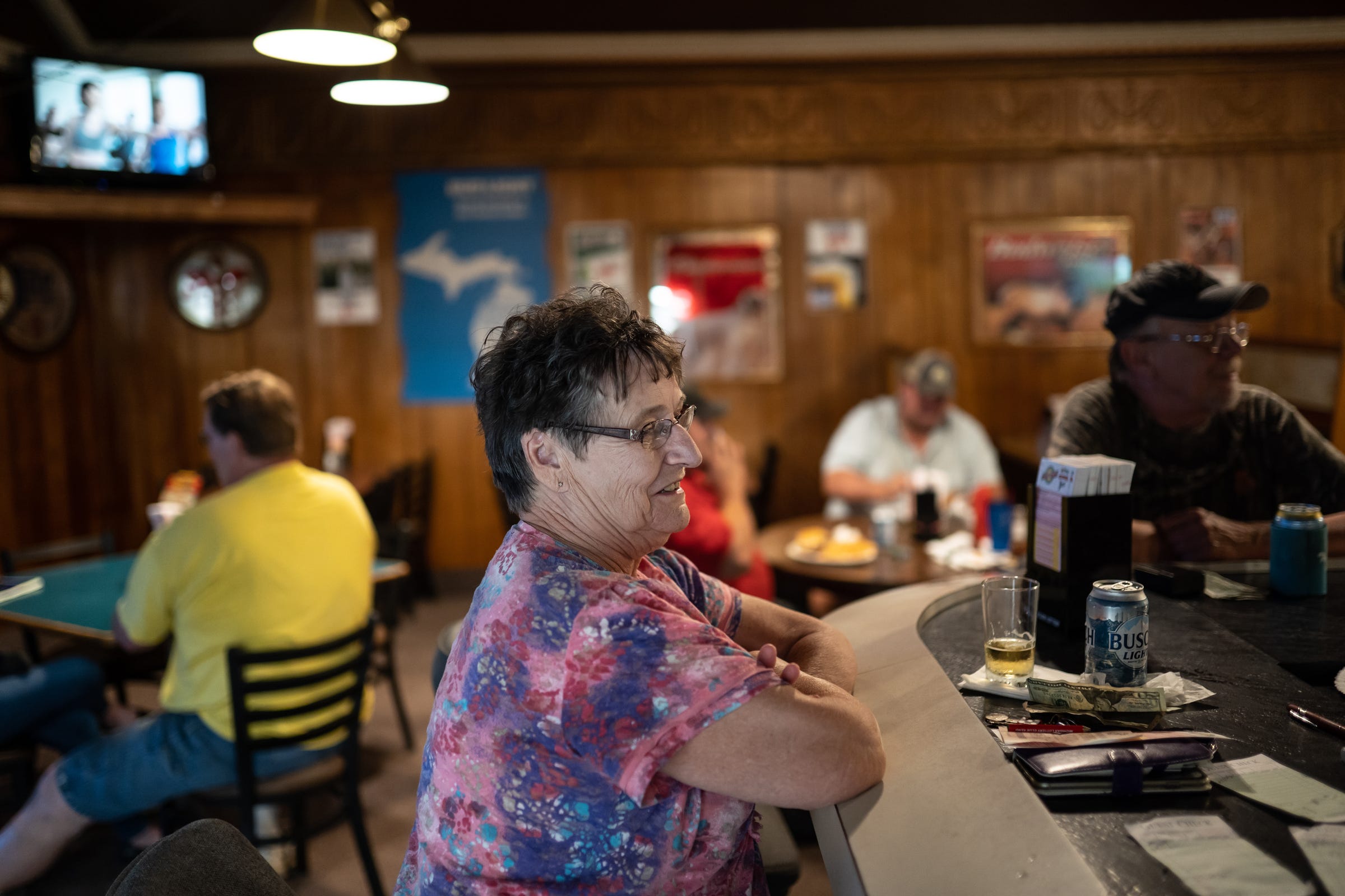 ​Gerrie Miller, who lives in nearby St. Charles, at the Family Tavern in July. She said she meets up with friends every night for happy hour.