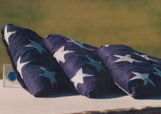 Three flags symbolized fallen airmen at a memorial service for those who died in a B-1B crash Sept. 28, 1987.