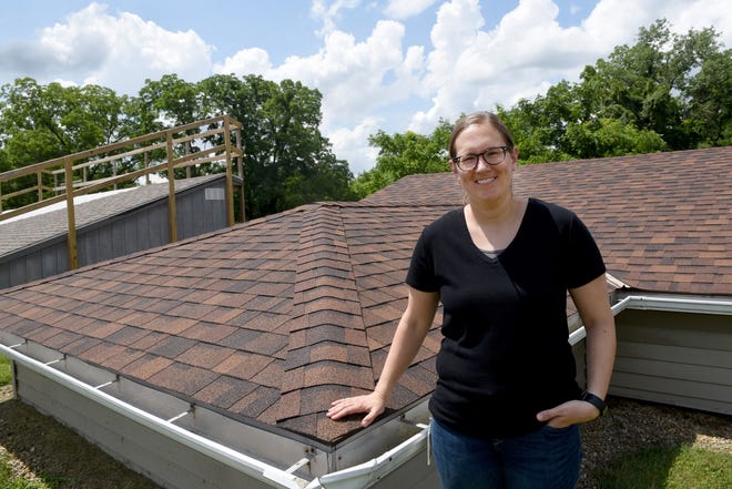 Sarah Jones, a senior engineer for Owens Corning in the Process and Materials Innovation Group in the Roofing Division, by the shingle decks built for field testing shingles at the Science and Technology Center in Granville.