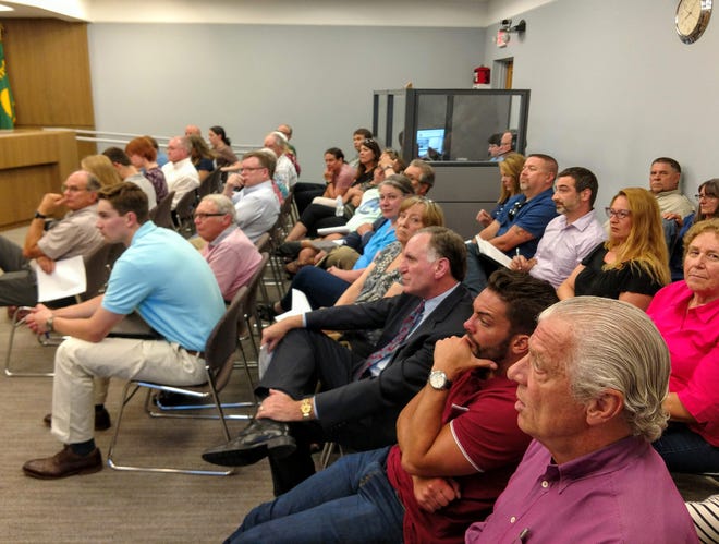 Farmington City Hall was packed for Monday's planning commission meeting, with many residents there in opposition to a proposed Burger King at Grand River and Lake Way.
