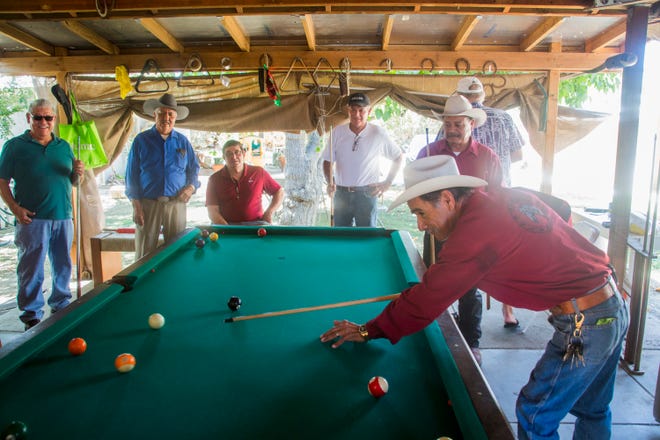 Armando Ruiz plays billiards at the home of Jesus Espinoza, who now hosts his friends for pool games in Thermal after complaining about racial discrimination at the Indio Senior Center.