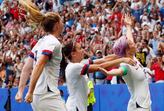 Megan Rapinoe, right, celebrates with teammates Alex Morgan and Sam Mewis after scoring a goal on a shot at goal against the Netherlands in the World Cup title match.