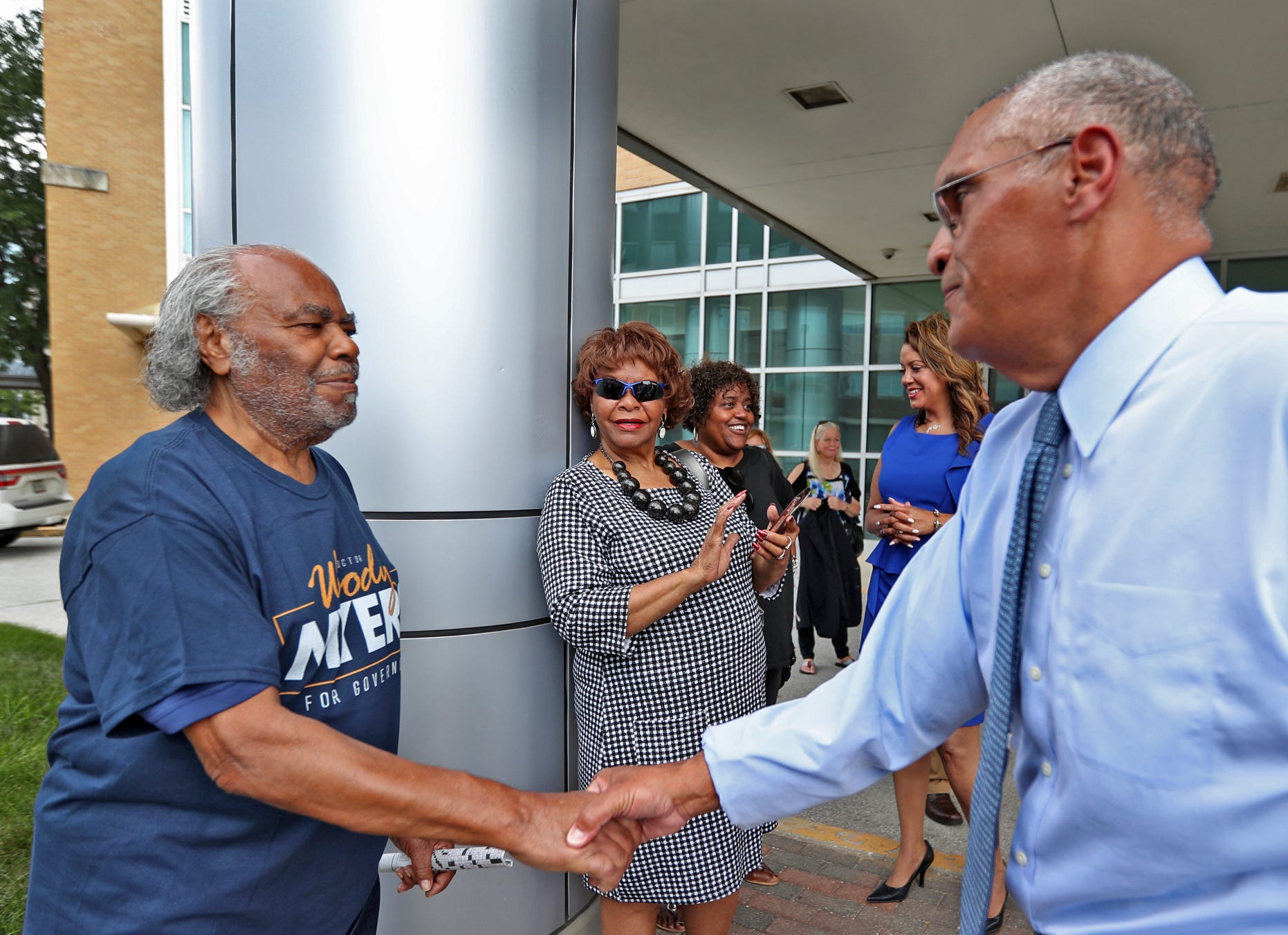 Woody Myers (right) shakes hands with one of his uncles, Herschel Tyler, after a press conference announcing Myers' bid for governor on Wednesday, July 10, 2019, at the old Wishard Emergency Department.