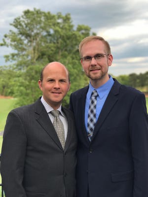 Joshua Payne-Elliott (right), pictured with his husband Layton Payne-Elliott, is suing the Archdiocese of Indianapolis.