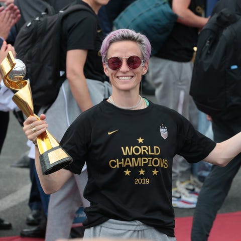 Megan Rapinoe poses with the World Cup trophy at...