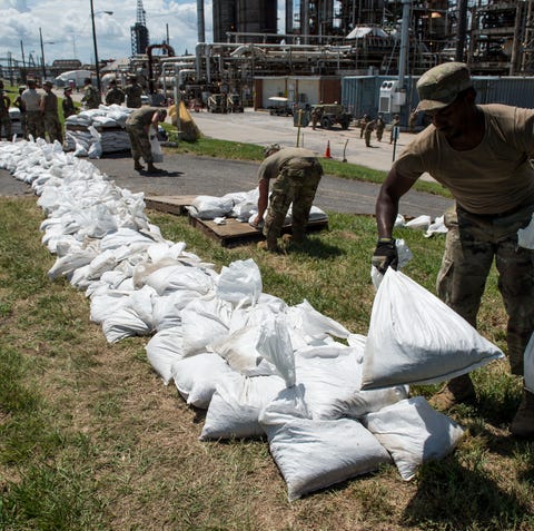 Army National Guard members put down sandbags at...