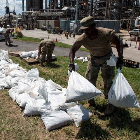 Army National Guard soldiers put down sandbags at...