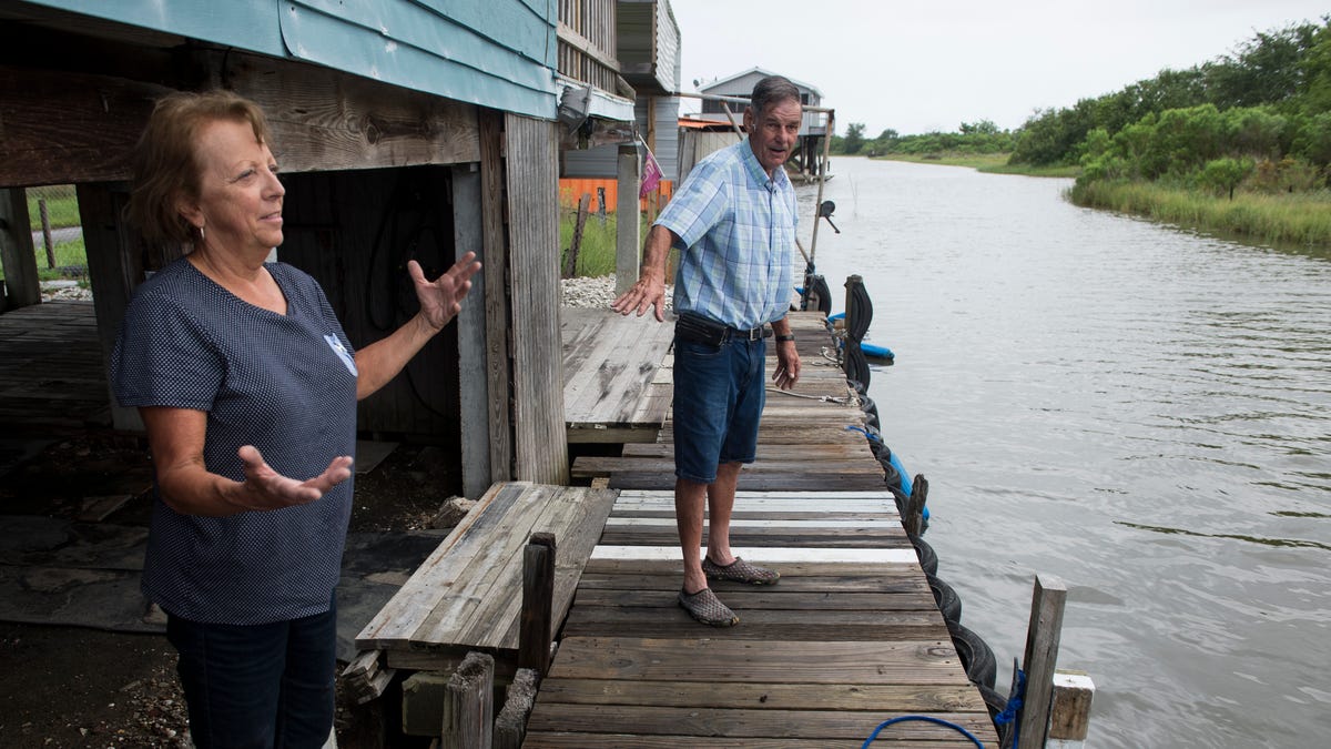 Linda, left, and Lee Morvant talk about the water level at their fish camp in Isle de Jean Charles, La., on Friday, July 12, 2019. Isle de Jean Charles is slowly shrinking due to rising sea levels. 