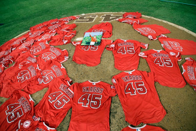 Jerseys with pitcher Tyler Skaggs' number are placed on the mound after the L.A. Angels completed a combined no-hitter against the Mariners on Friday.