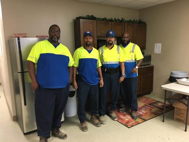 Sanitation truck driver Kevin Clark, second from right, has joined with fellow Republic Services employees from Memphis and nearby Millington, Tenn., in filing a discrimination complaint against their employer, the second-largest waste management company in the US, according to NASDAQ figures.