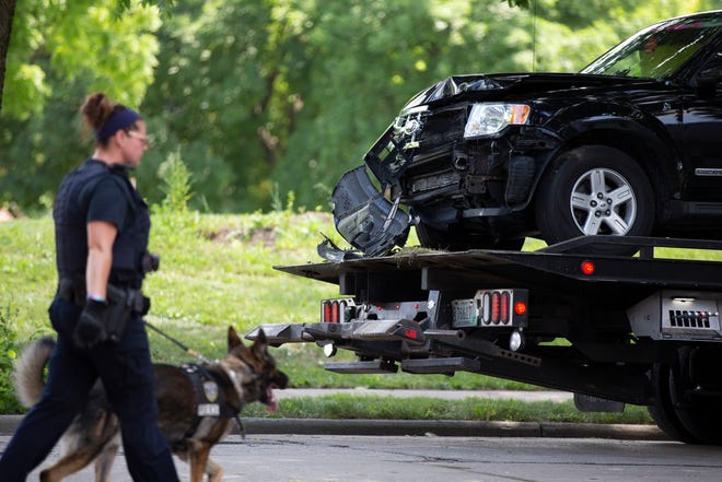 An SUV driven by the suspect in the fatal shooting of a 3-year-old child in a road rage incident Saturday is towed from the scene where it crashed.