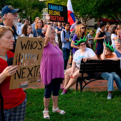 People take part in a "Lights For Liberty" rally...