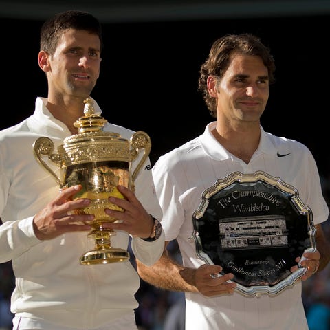 Novak Djokovic and Roger Federer with their...